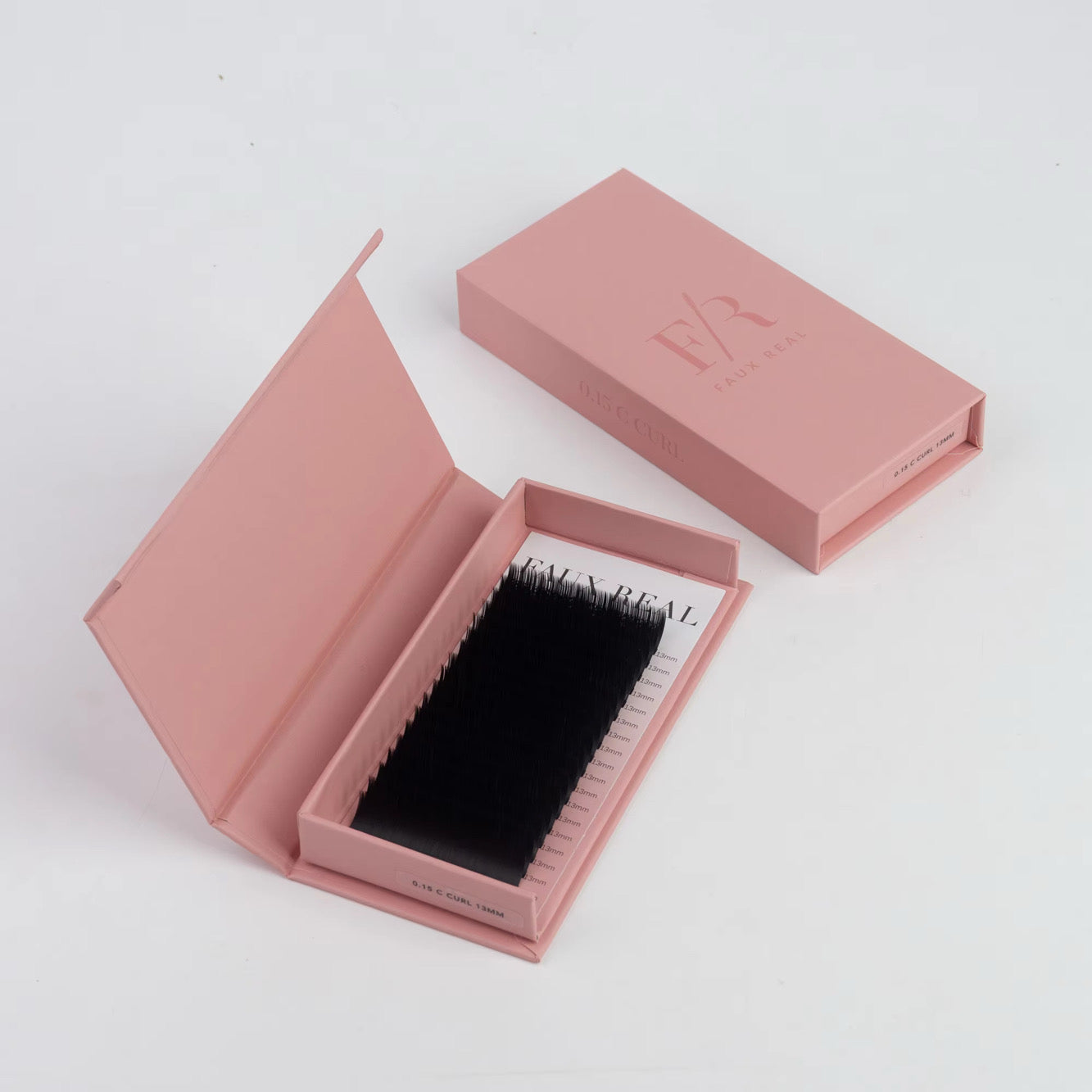 Pink box with false eyelashes on a white background