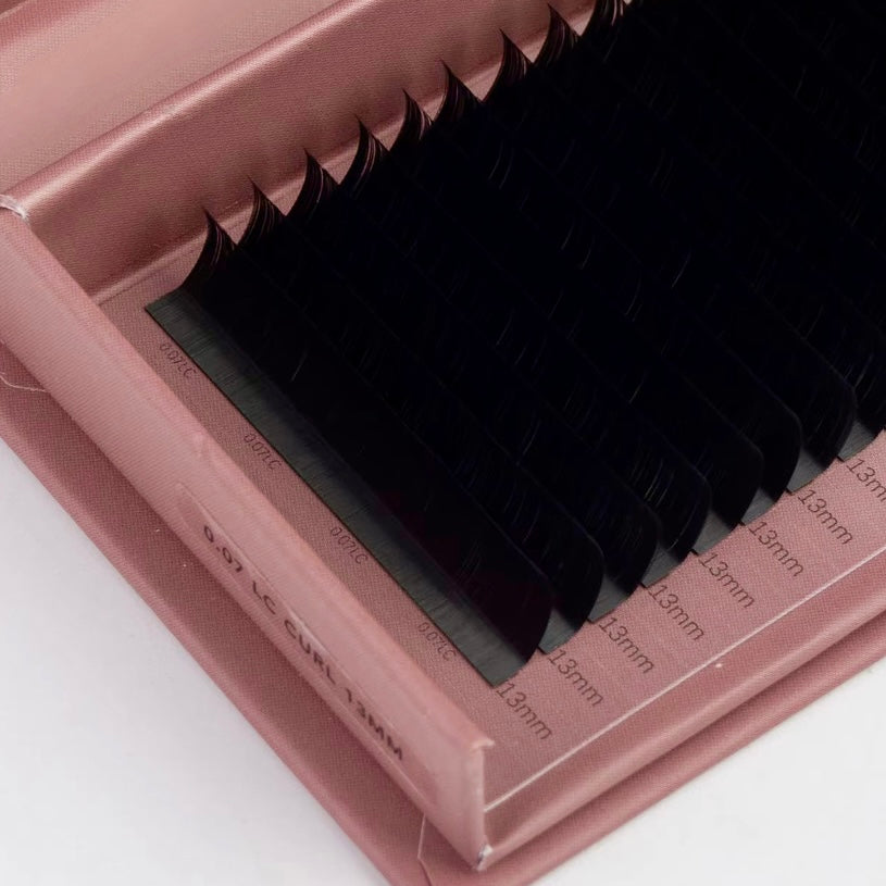 Pink case with false eyelashes on a white background